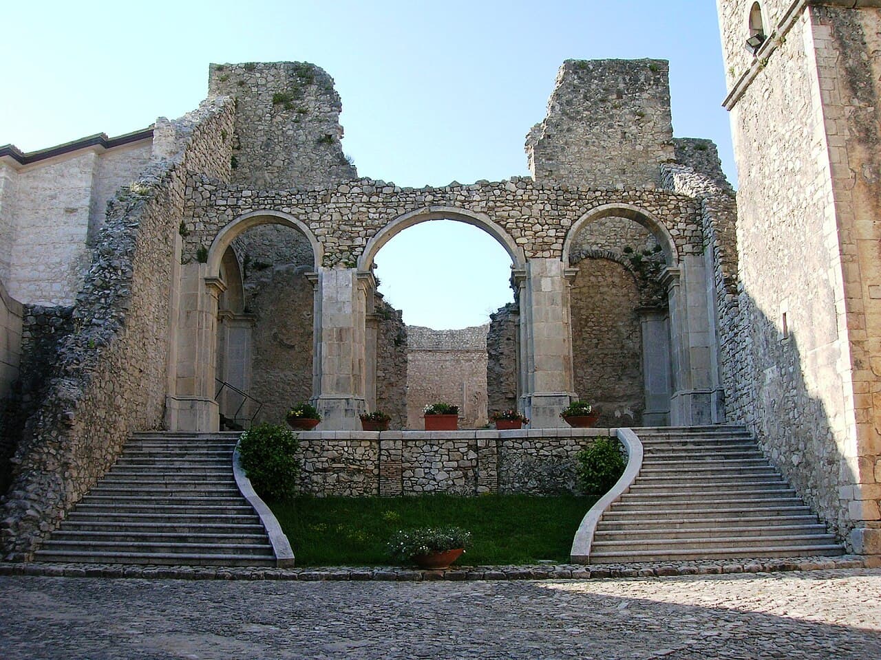 Stone church and courtyard at Goleto Abbey